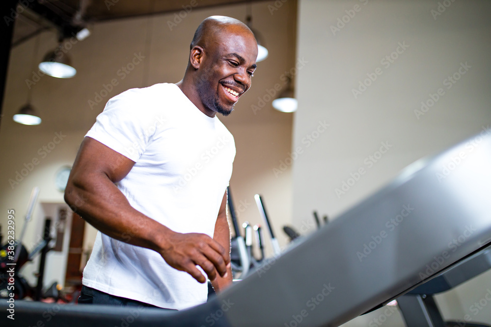 latino man in sportswear running on treadmill at gym latino man in sportswear running on treadmill at gym