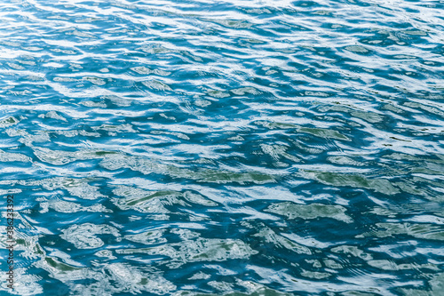 Small waves on the water. Ripples. Abstract background for wallpaper.