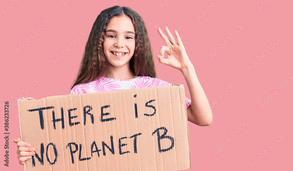 Cute hispanic child girl holding there is no planet b banner doing ok sign with fingers, smiling friendly gesturing excellent symbol Cute hispanic child girl holding there is no planet b banner doing ok sign with fingers, smiling friendly gesturing excellent symbol