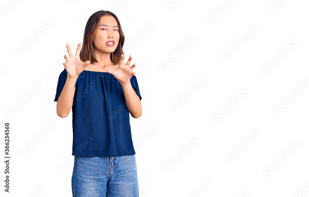 Young beautiful chinese girl wearing casual clothes disgusted expression, displeased and fearful doing disgust face because aversion reaction. with hands raised Young beautiful chinese girl wearing casual clothes disgusted expression, displeased and fearful doing disgust face because aversion reaction. with hands raised