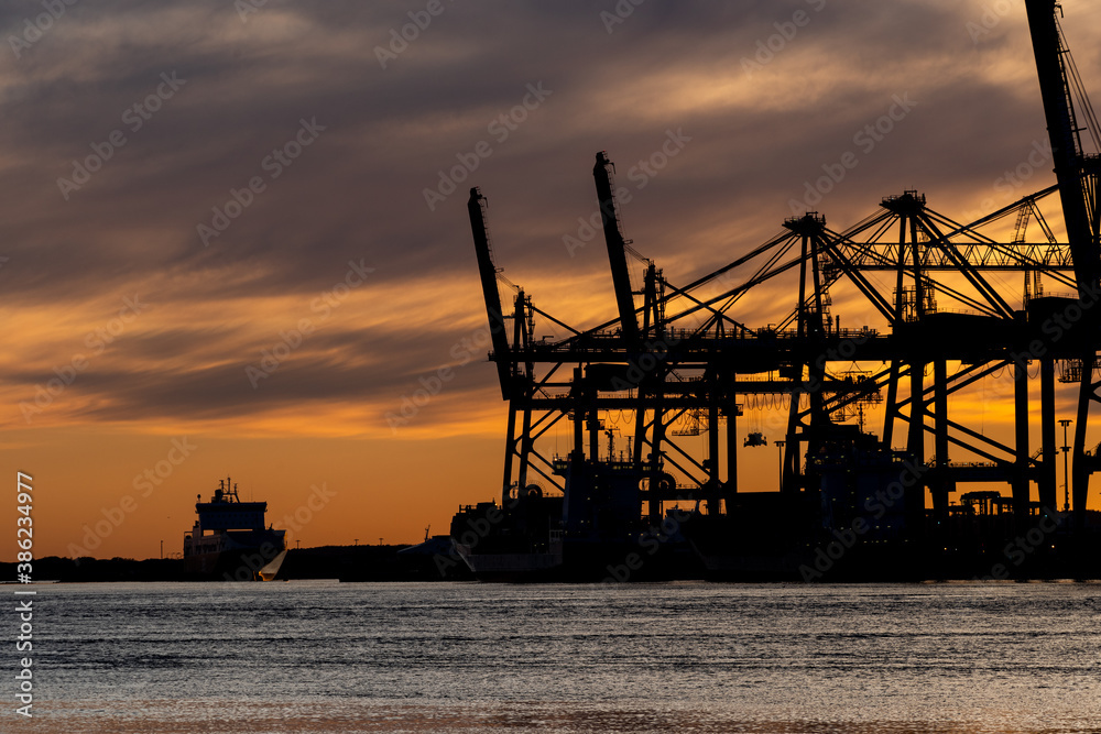 Silhouettes of ship to shore cranes at sunset..