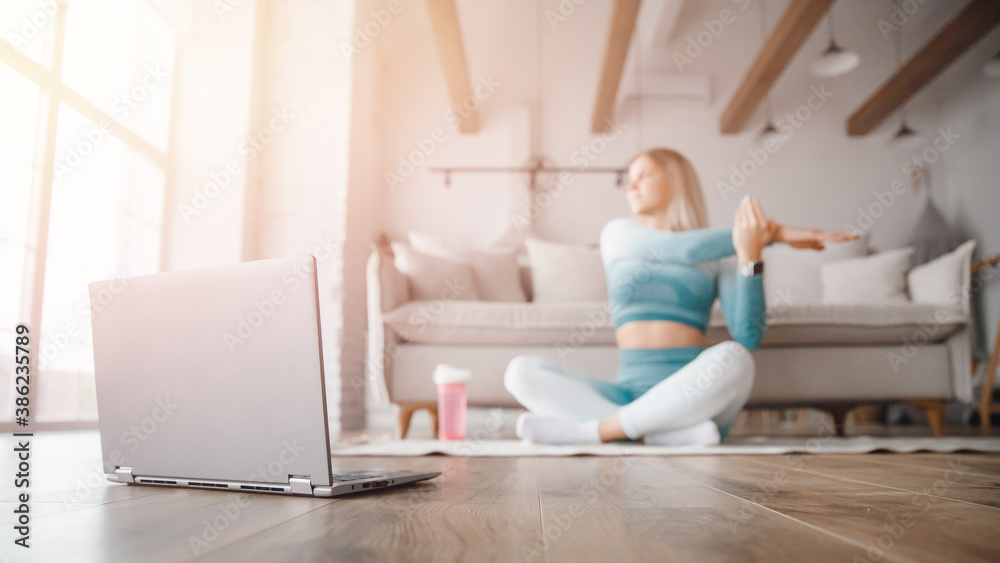 Naklejka premium Fitness woman blogger recording video on camera, training home in living room. Concept Lifestyle influencer sport and recreation