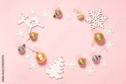 Christmas pink flat lay background with holiday decorations.