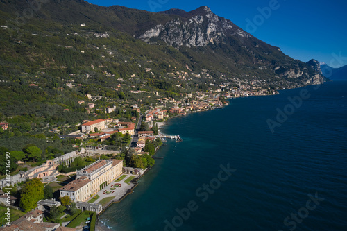 Villa on Lake Garda in the background Alps and blue sky. Panoramic view of the Villa in the town of Gargnano on Lake Garda Italy. High-altitude aerial view of the architecture on Lake Garda.