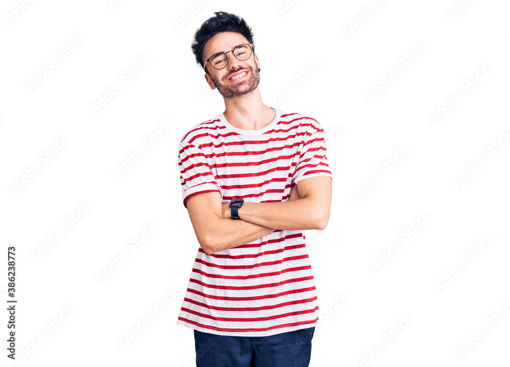 Young hispanic man wearing casual clothes happy face smiling with crossed arms looking at the camera. positive person. Young hispanic man wearing casual clothes happy face smiling with crossed arms looking at the camera. positive person.