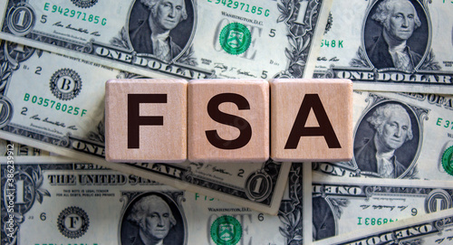 Canvas-taulu Concept word 'FSA, flexible spending account' on cubes on a beautiful  background from dollar bills