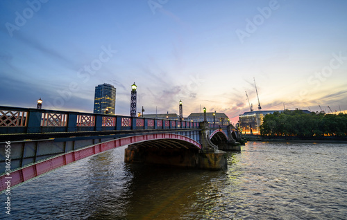 Lambeth Bridge in central London, UK. Lambeth Bridge spans the River Thames connecting Lambeth and Westminster. Wide angled view taken in the evening shortly after sunset. photo
