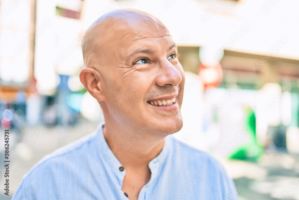Middle age bald man smiling happy walking at the city. Middle age bald man smiling happy walking at the city.