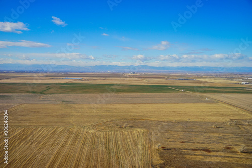 Aerial view of of farm in suburban of Denver in Colorado and the country road 