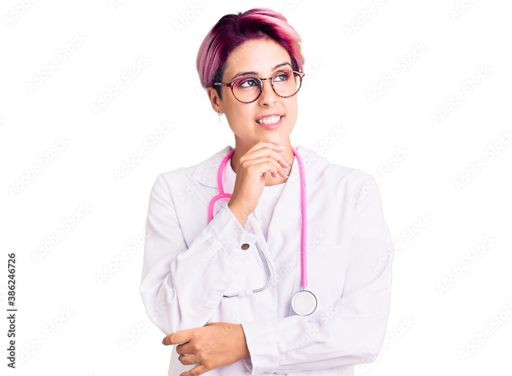Young beautiful woman with pink hair wearing doctor uniform with hand on chin thinking about question, pensive expression. smiling with thoughtful face. doubt concept.