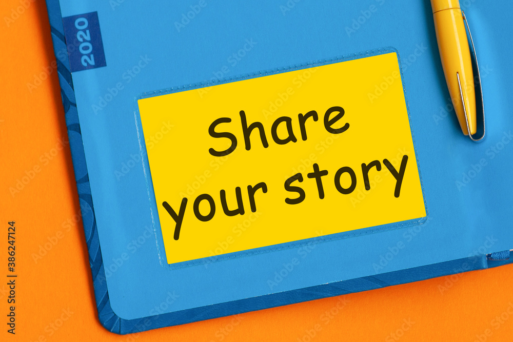 The word Share your story is written in marker on the yellow paper for notes.