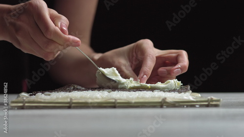 Lady preparing sushi roll - people with favorite dish Japanese food concept
