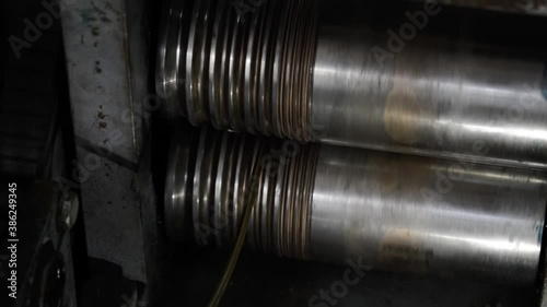 jewelry rolls. jeweler makes thin gold metal wire with rolls at workplace in jewelry workshop close up