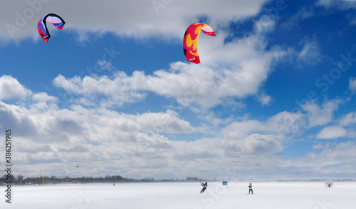Boarder and skier snowkiting on Lake Simcoe photo