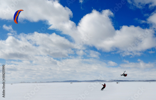 Snowkiter and aerial manouver on Lake Simcoe Ontario photo