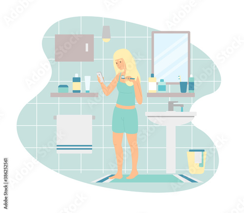 Woman using smartphone while brushing teeth in morning