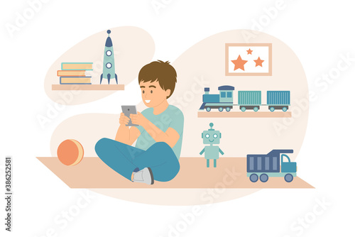 Happy child using digital device near toys
