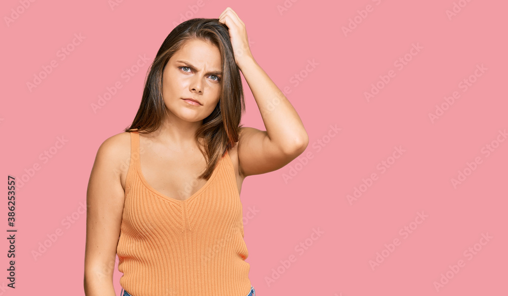 Young caucasian woman wearing casual clothes confuse and wonder about question. uncertain with doubt, thinking with hand on head. pensive concept. Young caucasian woman wearing casual clothes confuse and wonder about question. uncertain with doubt, thinking with hand on head. pensive concept.