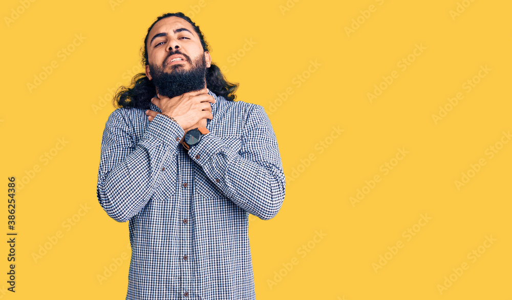 Young arab man wearing casual clothes shouting suffocate because painful strangle. health problem. asphyxiate and suicide concept. Young arab man wearing casual clothes shouting suffocate because painful strangle. health problem. asphyxiate and suicide concept.