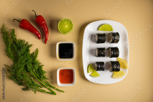 A set of sushi rolls is served on a light background. Japanese menu. Delicious traditional japanese food with sushi rolls.