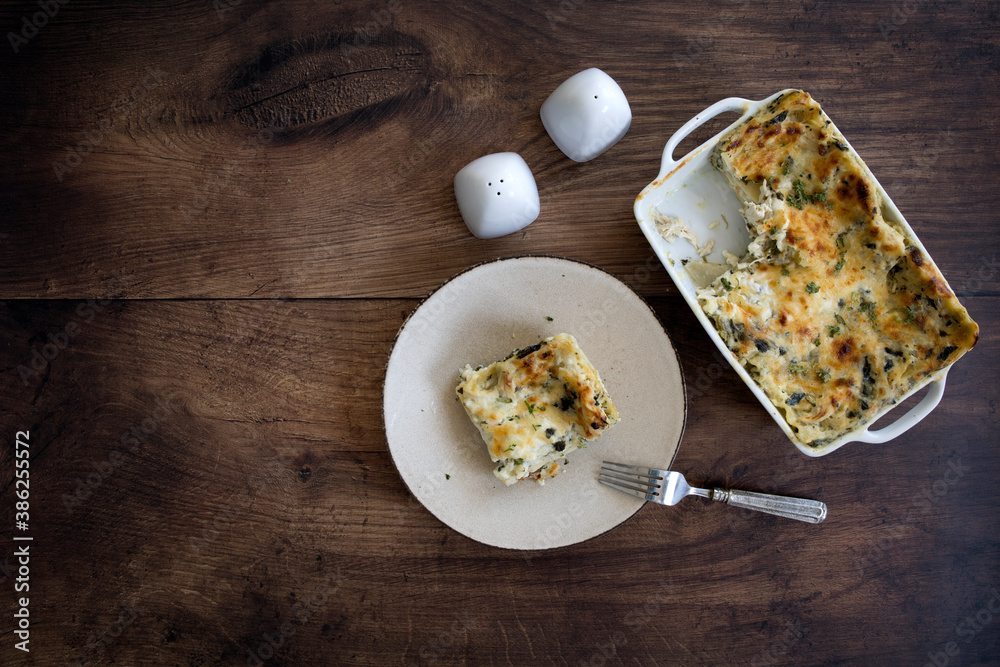 Chicken Spinach Lasagna on a Wooden Background Chicken Spinach Lasagna on a Wooden Background