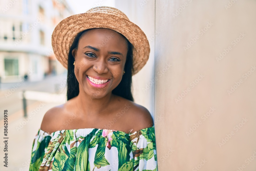 Young african american tourist woman on vacation smiling happy at the city.