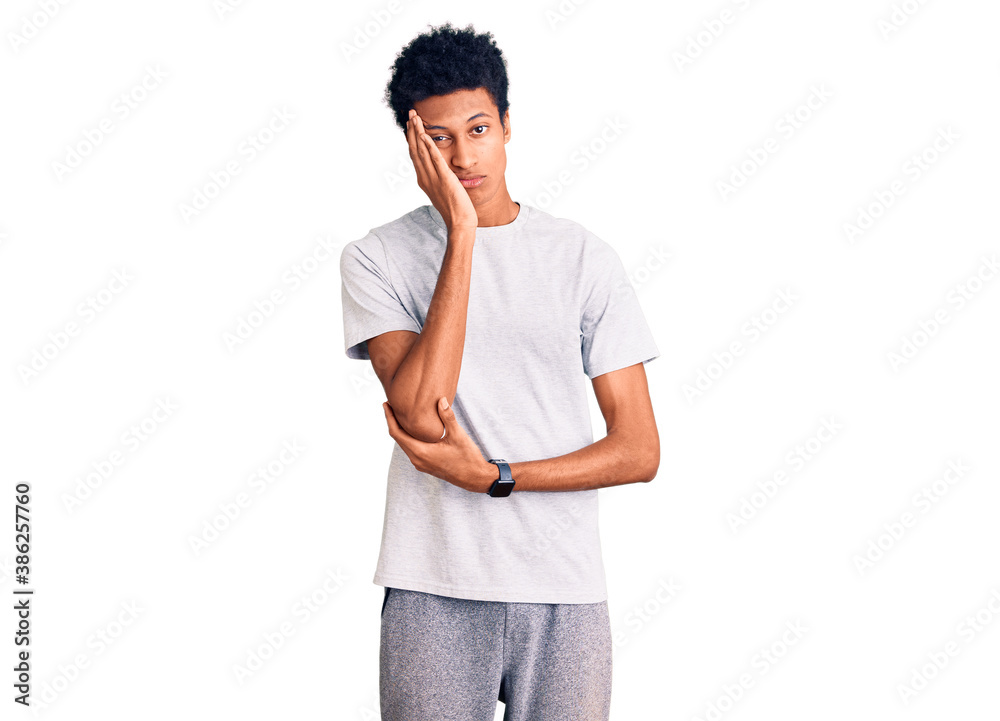 Young african american man wearing casual clothes thinking looking tired and bored with depression problems with crossed arms. Young african american man wearing casual clothes thinking looking tired and bored with depression problems with crossed arms.