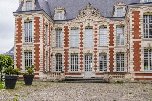 Beautiful architecture of ancient French buildings: Brick and stone building known today as Hotel de Berny built during the years 1633 and 1634. Amiens. Somme department, Picardie, France.  photo