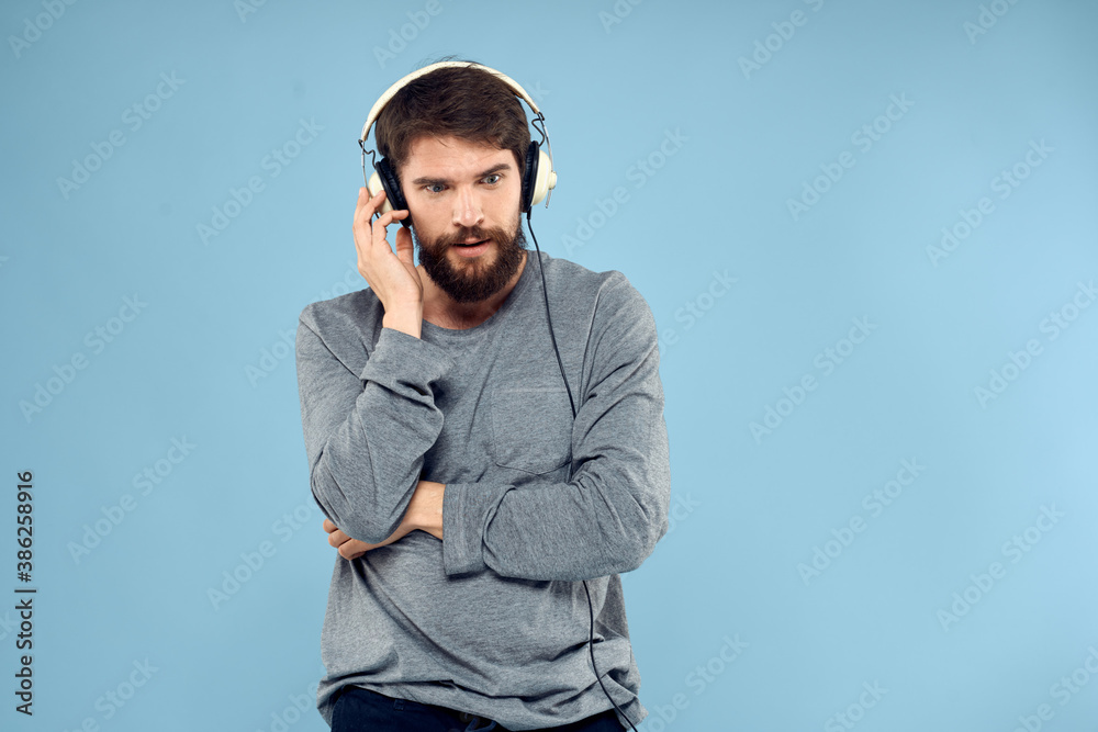 man wearing headphones music emotion lifestyle modern style technology blue background man wearing headphones music emotion lifestyle modern style technology blue background
