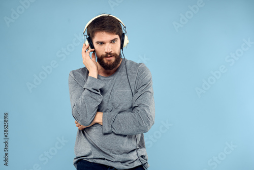 man wearing headphones music emotion lifestyle modern style technology blue background