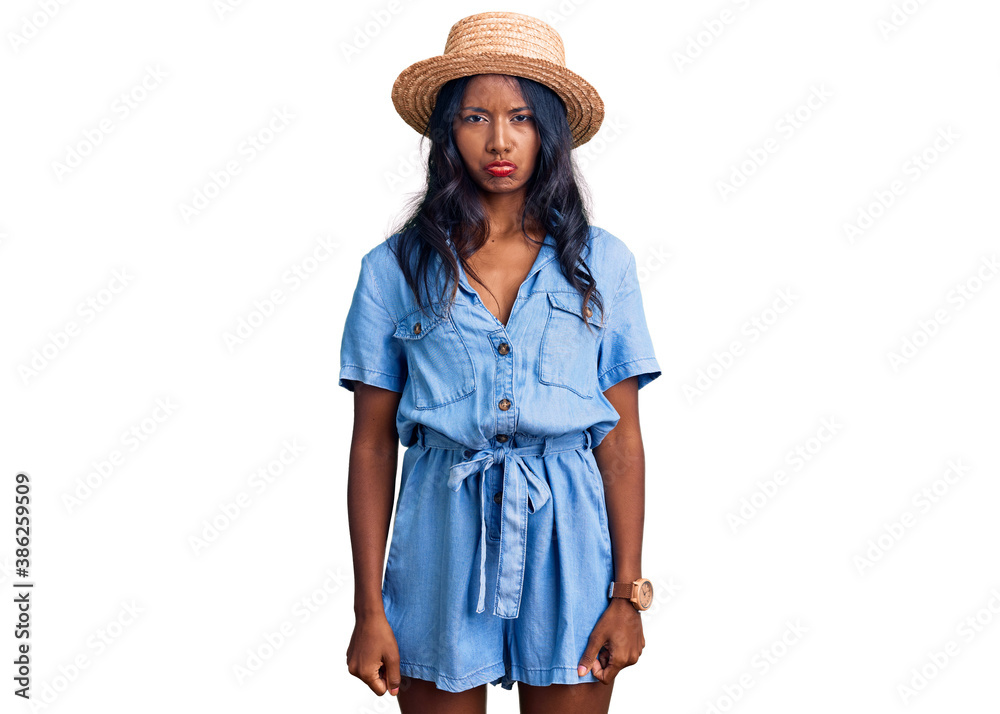 Young indian girl wearing summer hat depressed and worry for distress, crying angry and afraid. sad expression. Young indian girl wearing summer hat depressed and worry for distress, crying angry and afraid. sad expression.