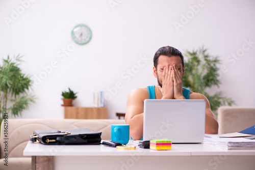 Young man working from house during pandemic