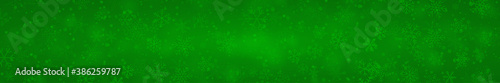 Christmas banner of snowflakes of different shapes, sizes and transparency on green background
