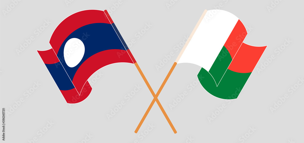 Crossed and waving flags of Madagascar and Laos Crossed and waving flags of Madagascar and Laos