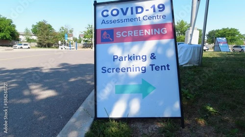 Covid-19 Assessment Centre Screening Parking and Screening Tent sign near hospital in the city. Coronavirus test for workers due pandemic. The fight with virus and second wave control. photo