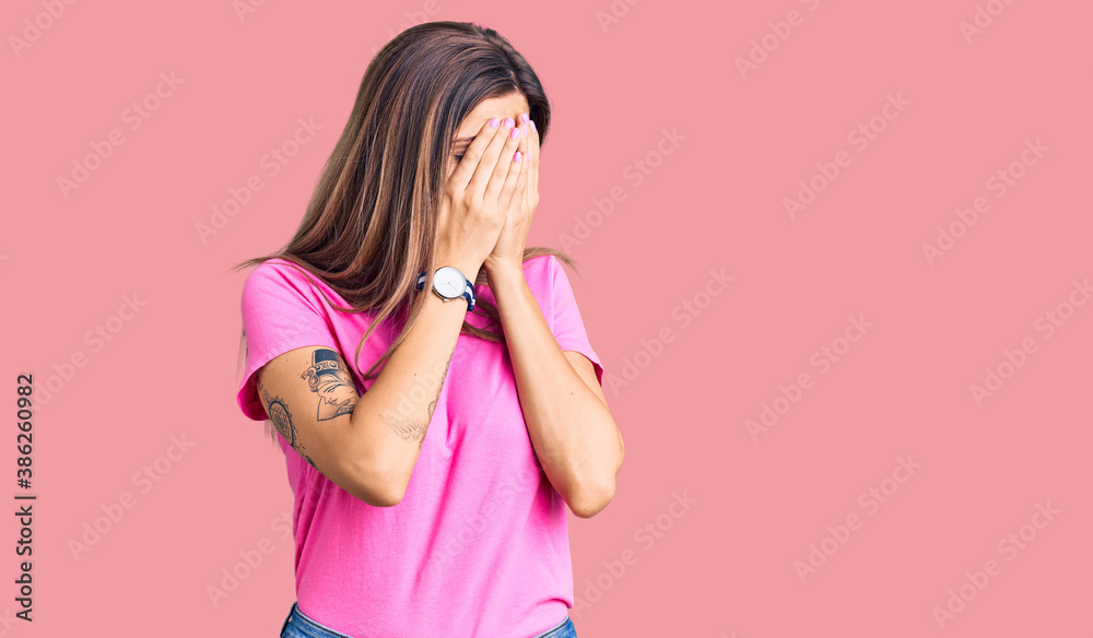 Beautiful caucasian woman wearing casual clothes with sad expression covering face with hands while crying. depression concept. Beautiful caucasian woman wearing casual clothes with sad expression covering face with hands while crying. depression concept.
