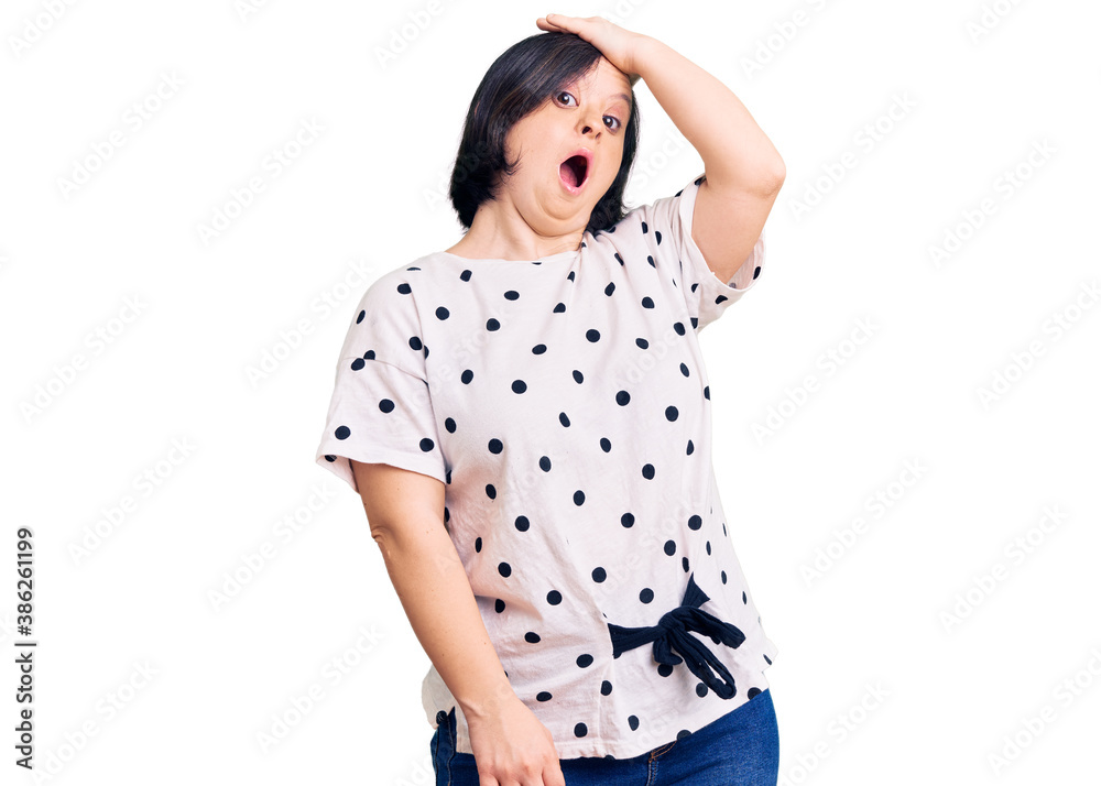 Brunette woman with down syndrome wearing casual clothes surprised with hand on head for mistake, remember error. forgot, bad memory concept. Brunette woman with down syndrome wearing casual clothes surprised with hand on head for mistake, remember error. forgot, bad memory concept.