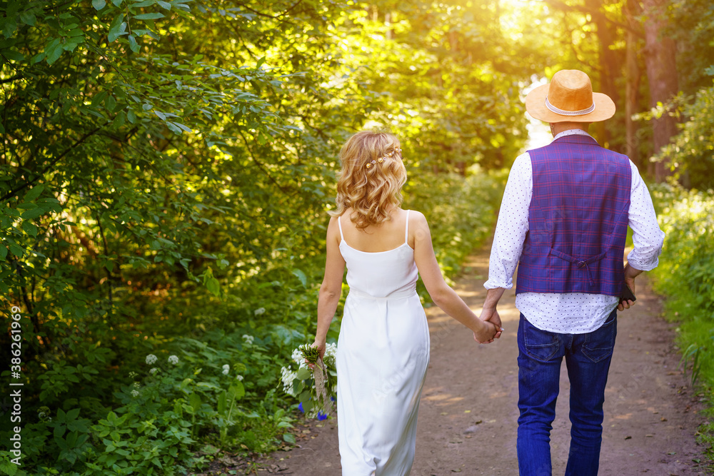 Young couple walking in the Park holding hands