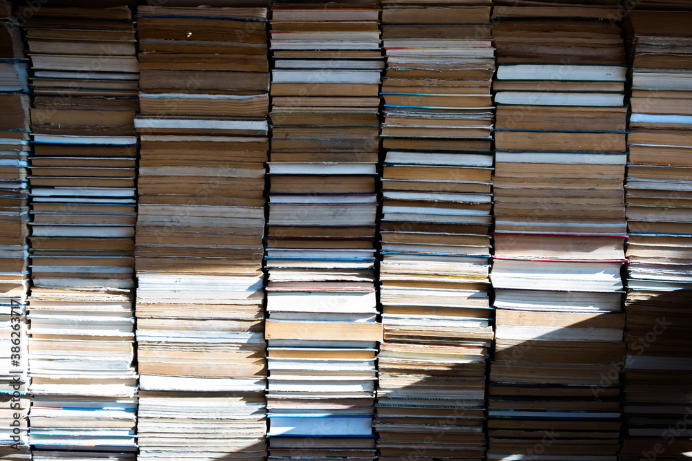 Background of all stacked books and sun light Background of all stacked books and sun light