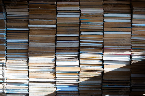 Background of all stacked books and sun light
