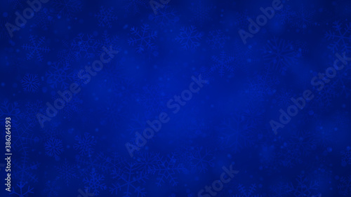 Christmas background of snowflakes of different shapes  sizes and transparency in blue colors