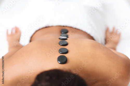 Black stones on naked black lady back