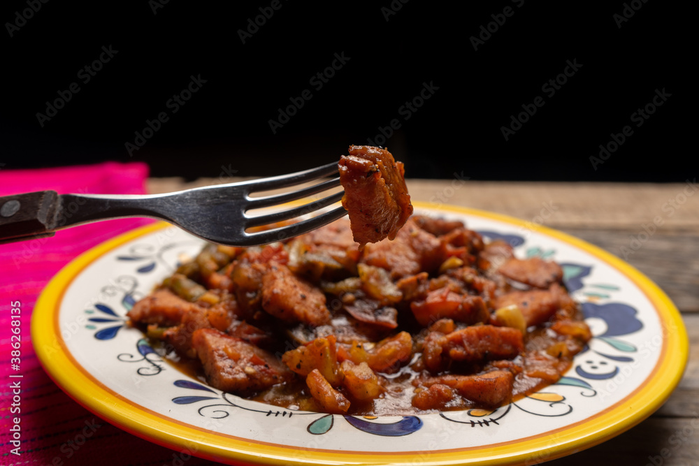 Pork chops with red sauce also called mexicana style on wooden background Pork chops with red sauce also called mexicana style on wooden background