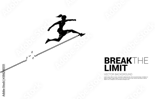 Silhouette of businesswoman jump to break the chain at foot. Concept of break the rule and limit in business.