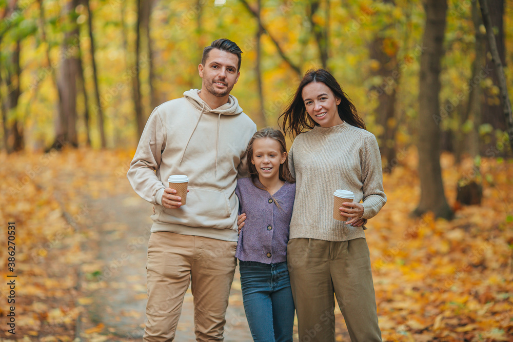 Portrait of happy family of three in autumn day