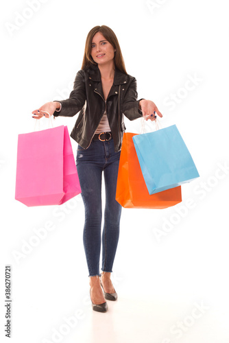 Girl in a leather jacket shows how little she bought on Black Friday. Girl surprised that she bought little on the day of sale. Little shopping on Black Friday sales day.