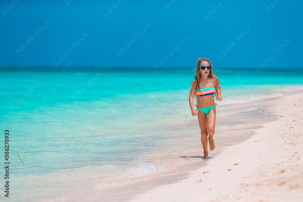 Adorable little girl at beach on her summer vacation