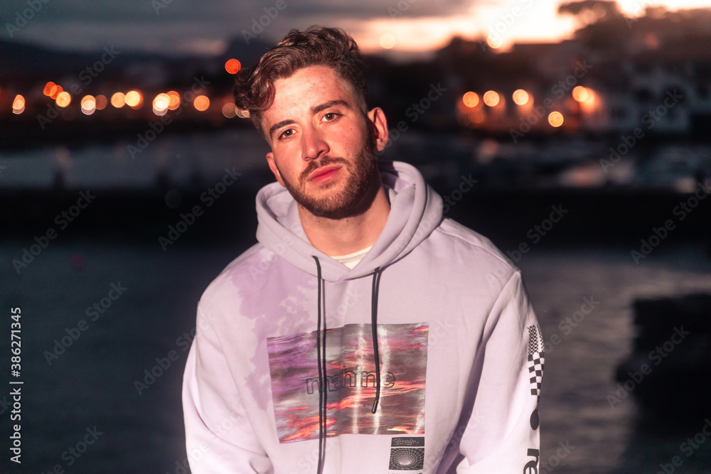 Young caucasian man posing at a sea port. Young caucasian man posing at a sea port.