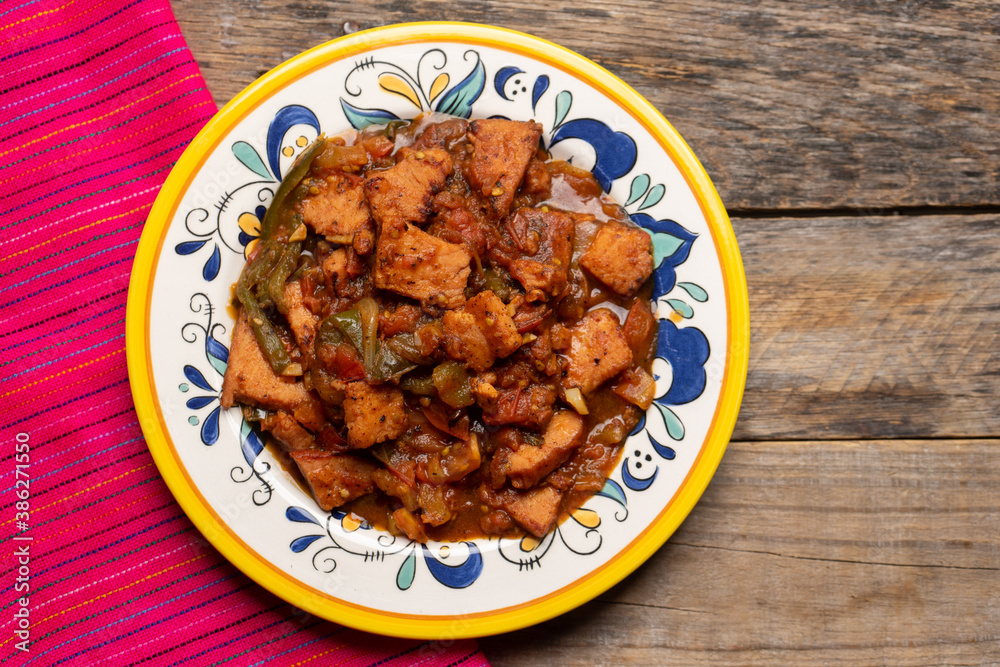 Pork chops with red sauce also called mexicana style on wooden background Pork chops with red sauce also called mexicana style on wooden background