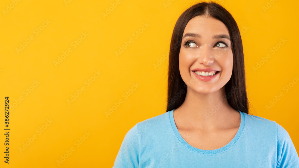 Portrait of smiling woman posing on yellow background Portrait of smiling woman posing on yellow background